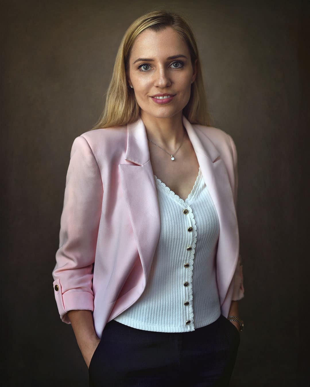 Dubai corporate portrait of a woman in a pink blazer, soft background