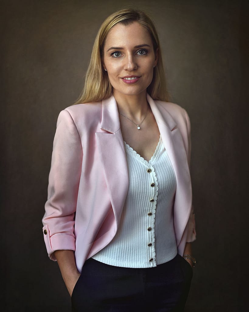 LinkedIn headshot in Dubai of a professional woman in a pink blazer.